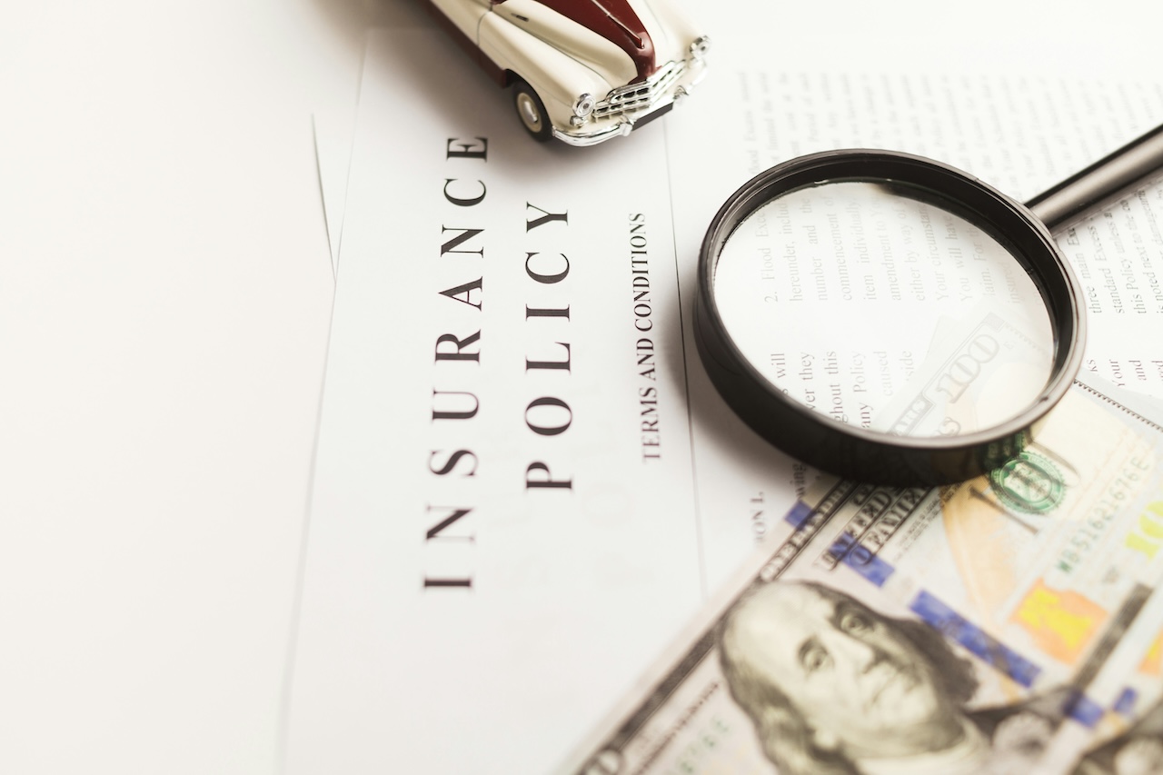 Close up of a piece of paper with the word "insurance policy" printed on it