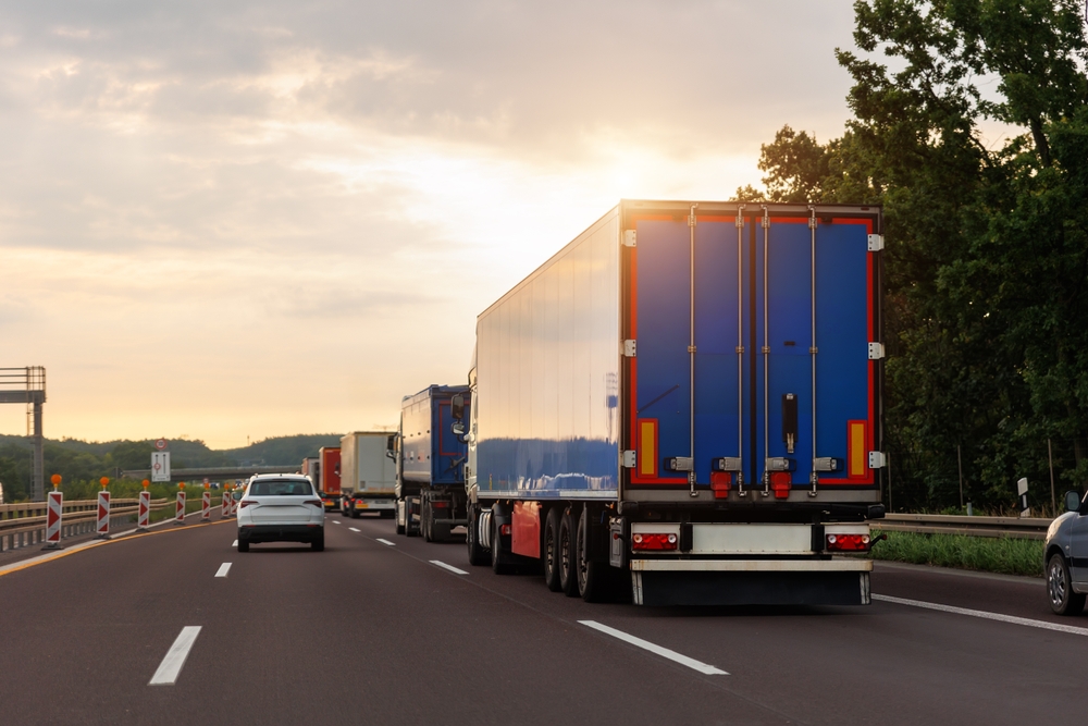 Semi-trucks and cars traveling on a multi-lane highway