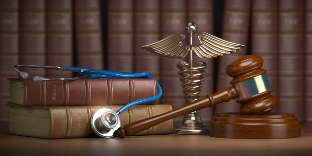 Gavel, stethoscope, law books, and a caduceus symbol representing personal injury law